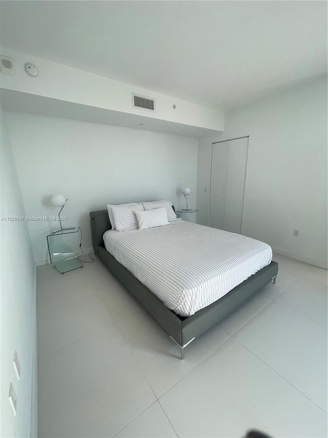 bedroom featuring a closet and light tile patterned flooring