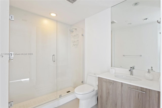 bathroom with vanity, toilet, and walk in shower