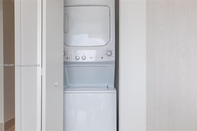 washroom with stacked washer / drying machine