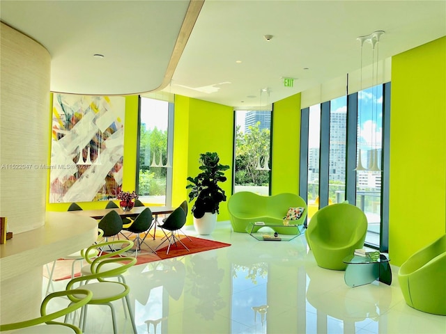 rec room with floor to ceiling windows and tile patterned flooring