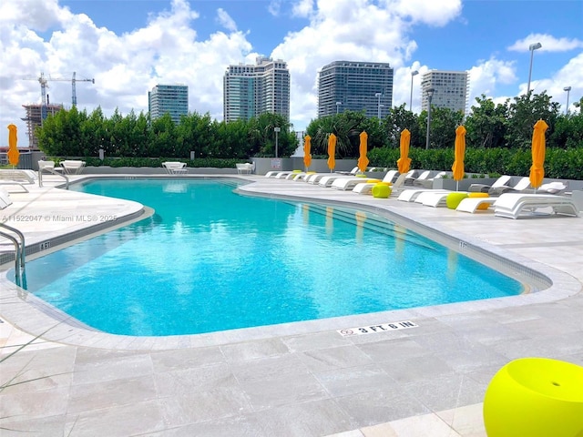 view of swimming pool with a patio