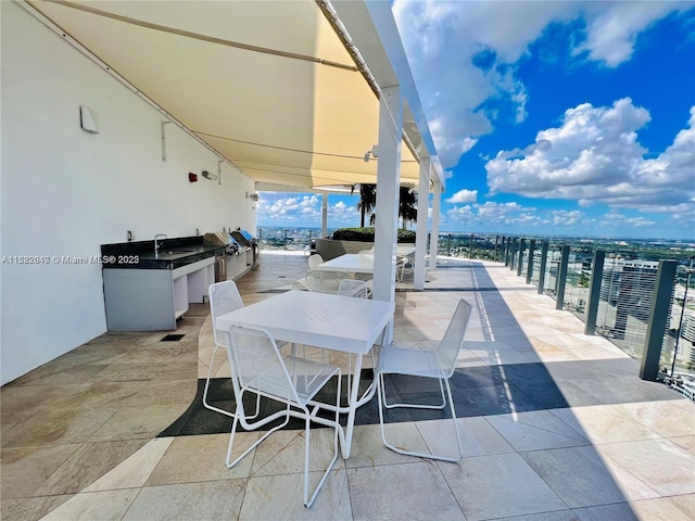 view of patio with area for grilling and sink