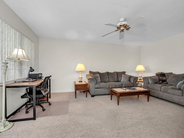 carpeted living room with ceiling fan and a textured ceiling