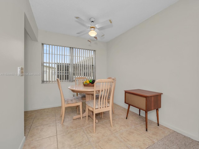 dining area featuring light tile patterned flooring and ceiling fan