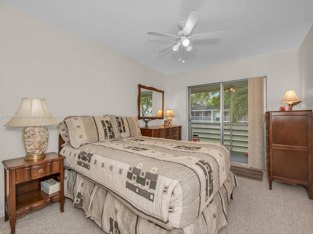 bedroom featuring light carpet, access to exterior, a textured ceiling, and ceiling fan