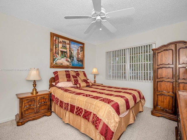 carpeted bedroom featuring a textured ceiling and ceiling fan