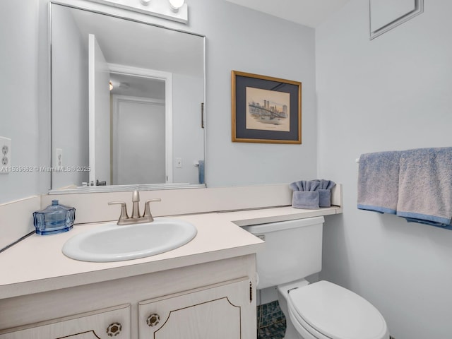 bathroom featuring vanity and toilet