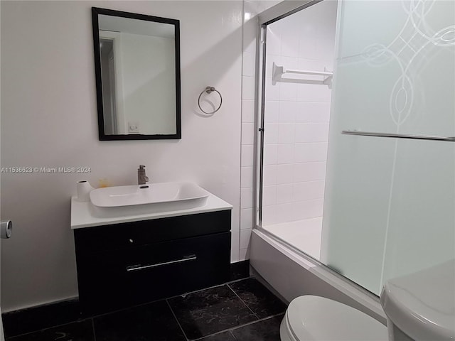 full bathroom with vanity, tile floors, shower / bath combination with glass door, and toilet