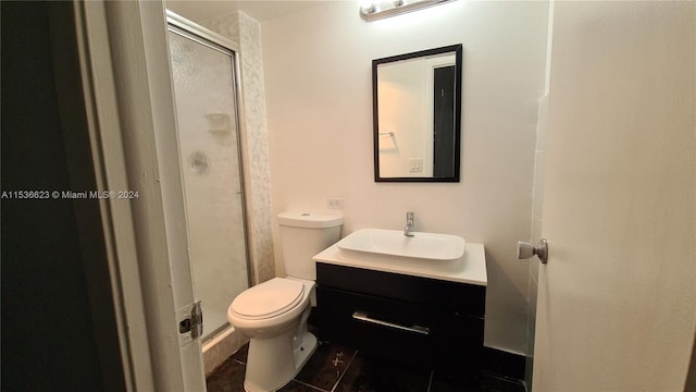 bathroom featuring an enclosed shower, toilet, vanity, and tile flooring