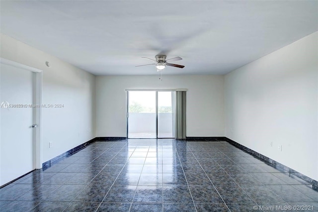 tiled empty room with ceiling fan