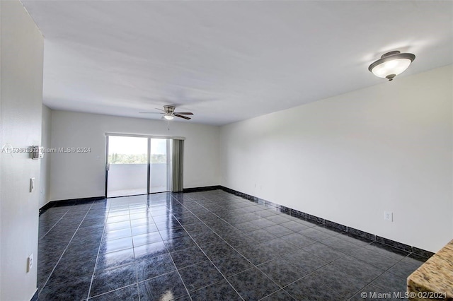 tiled empty room with ceiling fan