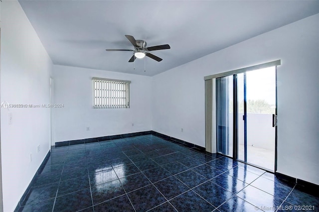 tiled spare room featuring ceiling fan