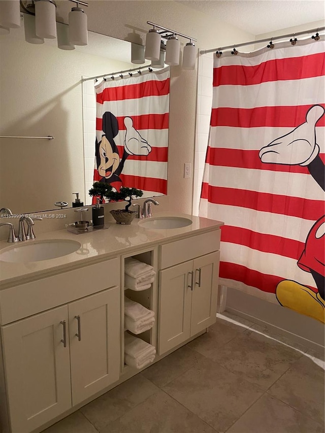 bathroom with double sink vanity and tile flooring