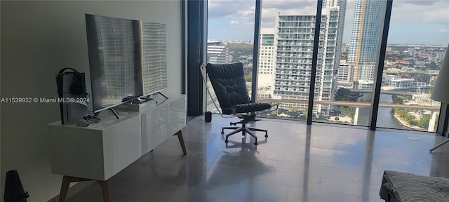 home office featuring a wall of windows and light tile floors