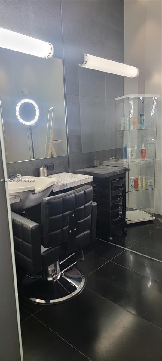 bathroom with tile floors, a shower with shower door, and large vanity