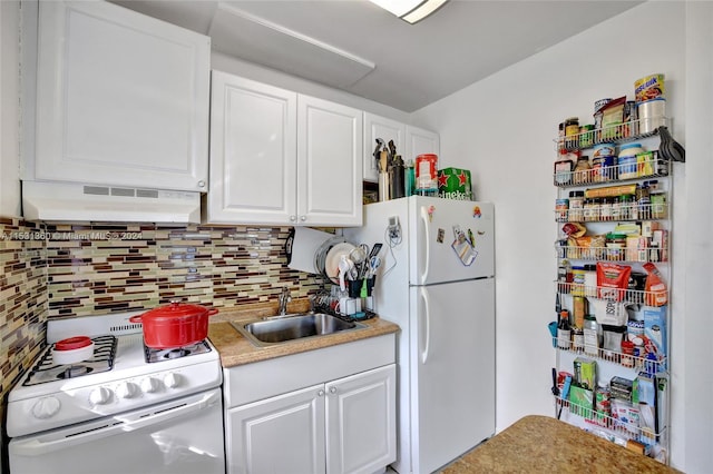 kitchen featuring sink, white appliances, wall chimney range hood, backsplash, and white cabinetry