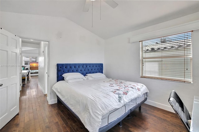 bedroom with dark wood-type flooring, ceiling fan, and lofted ceiling