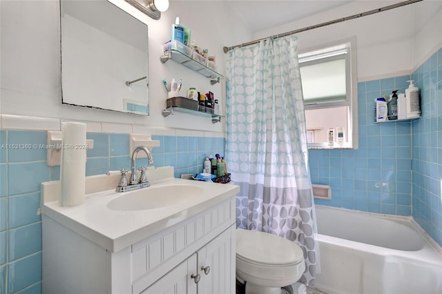 full bathroom with shower / bath combo with shower curtain, vanity, tile walls, tasteful backsplash, and toilet