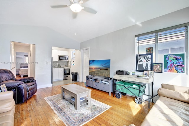 living room with light hardwood / wood-style flooring, ceiling fan, and vaulted ceiling