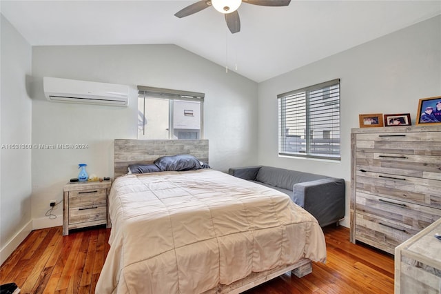 bedroom featuring wood-type flooring, ceiling fan, lofted ceiling, and a wall mounted AC