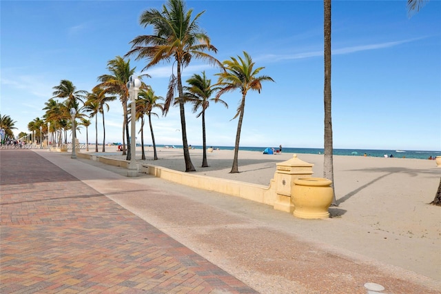 surrounding community with a beach view and a water view