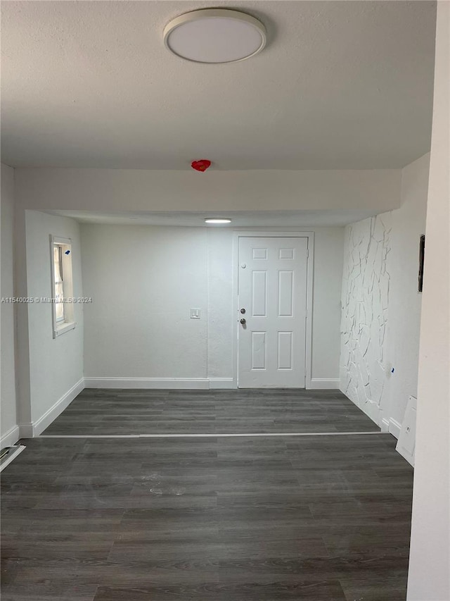 spare room with dark hardwood / wood-style flooring