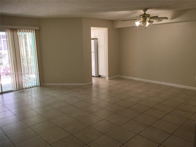 tiled empty room featuring plenty of natural light, a textured ceiling, and ceiling fan