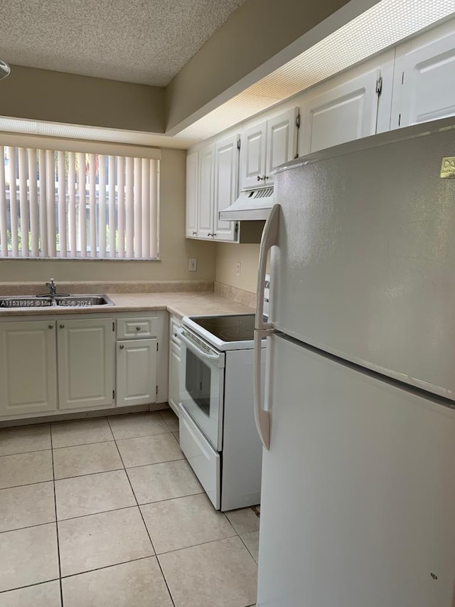 kitchen featuring white cabinetry, white appliances, premium range hood, and sink