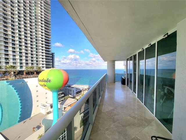 balcony featuring a pool and a water view