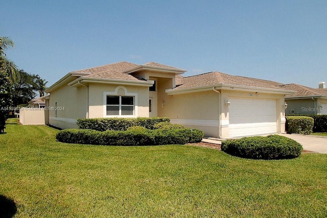 view of front of property with a front lawn and a garage