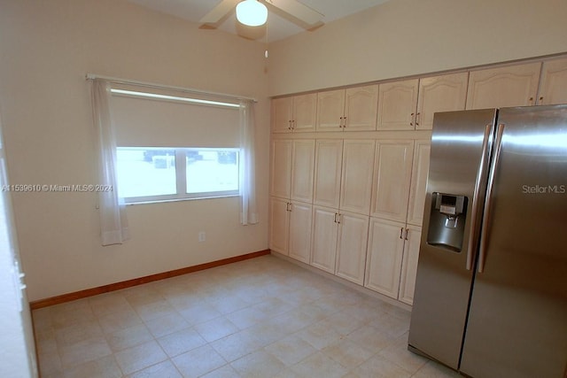 kitchen featuring light tile floors, stainless steel fridge with ice dispenser, and ceiling fan