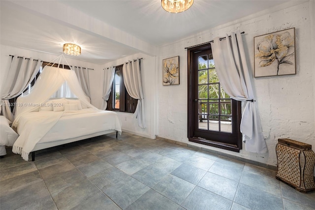 bedroom with a notable chandelier and access to outside