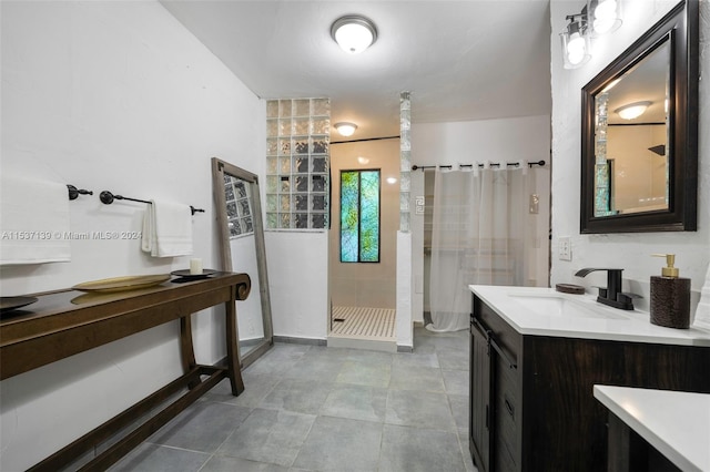 bathroom featuring vanity and curtained shower