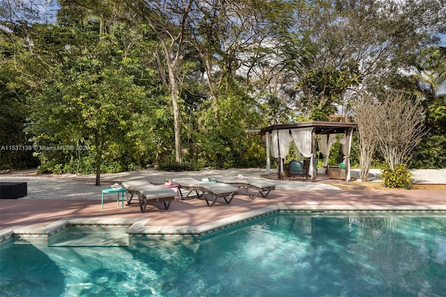 view of pool featuring a gazebo and a patio