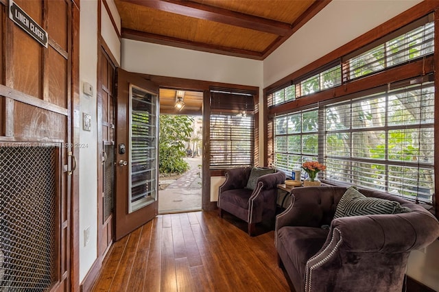 living room with wooden ceiling, dark hardwood / wood-style flooring, and beamed ceiling