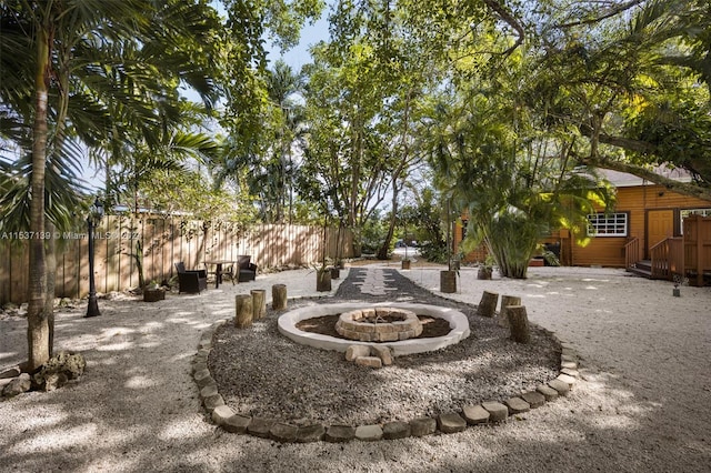 view of property's community with a patio and a fire pit