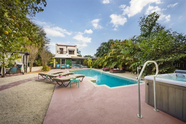 view of pool with a hot tub and a patio area