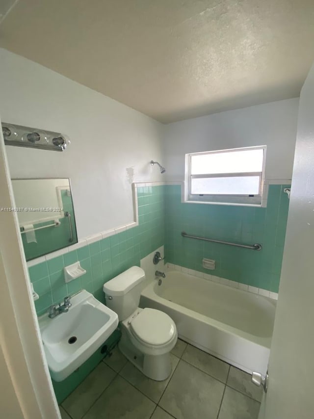 bathroom featuring backsplash, tile walls, sink, tile flooring, and toilet