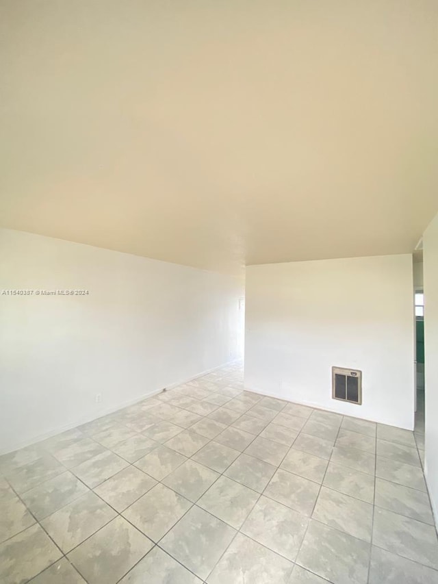 spare room featuring light tile floors