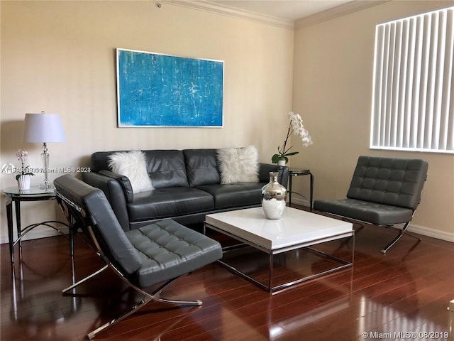 living room with dark hardwood / wood-style flooring and ornamental molding