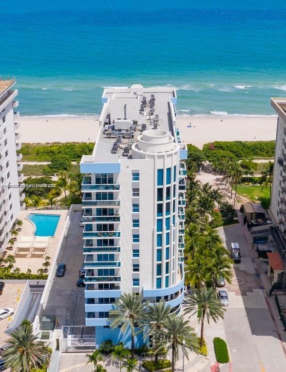 exterior space with a water view and a view of the beach