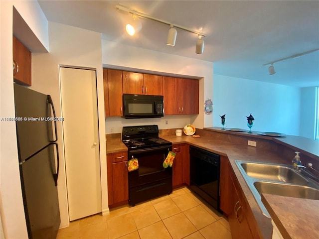 kitchen featuring sink, track lighting, black appliances, and light tile floors