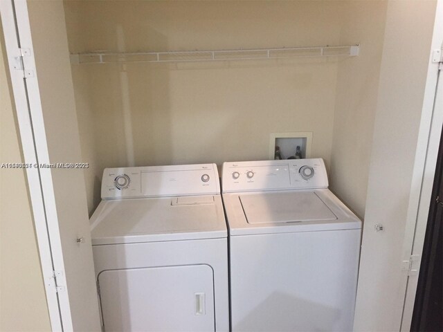 clothes washing area with washing machine and clothes dryer and laundry area