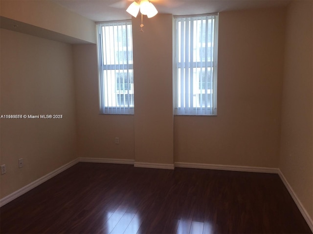 unfurnished room featuring dark hardwood / wood-style floors and ceiling fan