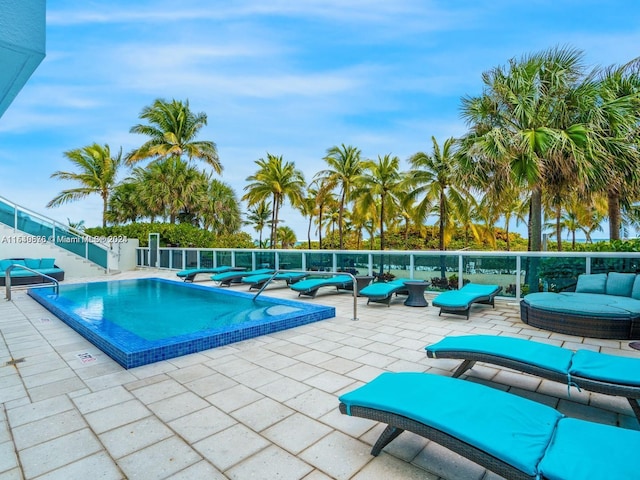 view of swimming pool featuring outdoor lounge area and a patio