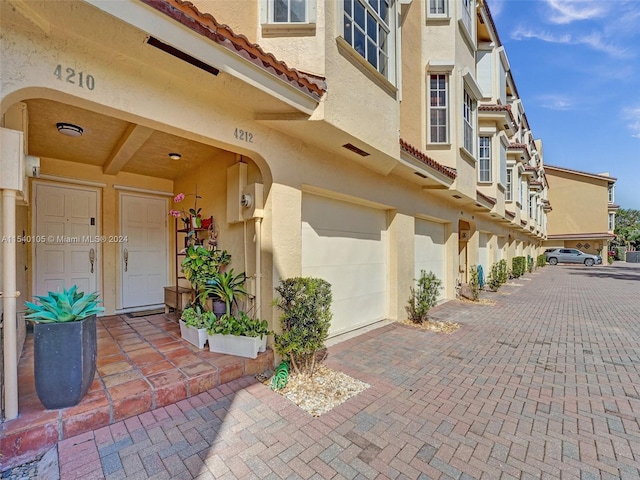 doorway to property with a garage