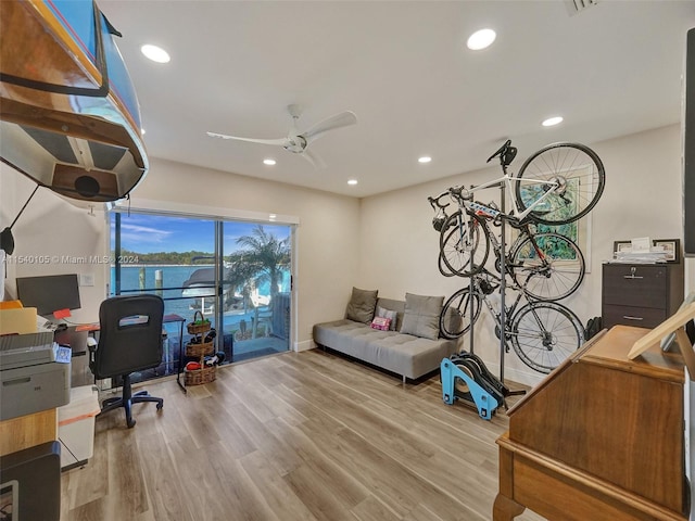 home office with ceiling fan and light wood-type flooring