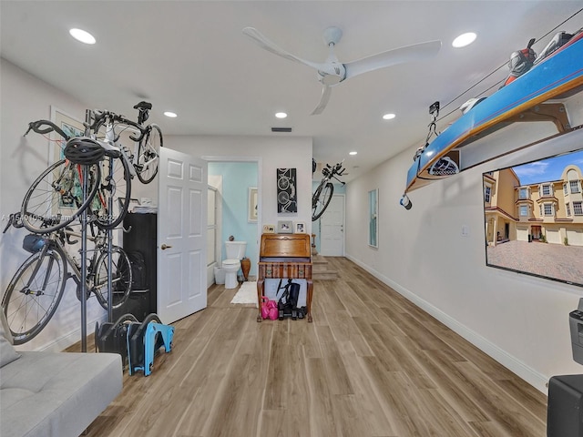 misc room with ceiling fan and light hardwood / wood-style flooring