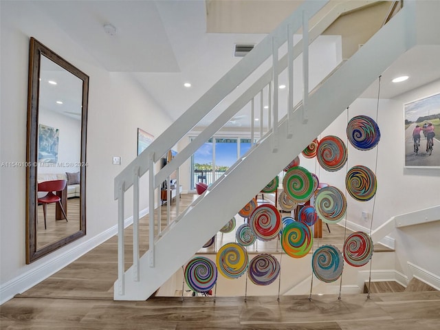 game room with a high ceiling and hardwood / wood-style flooring