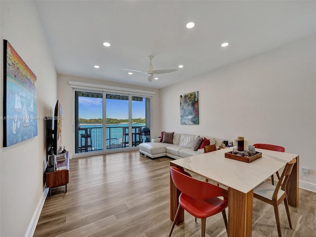 dining space featuring light hardwood / wood-style floors and ceiling fan